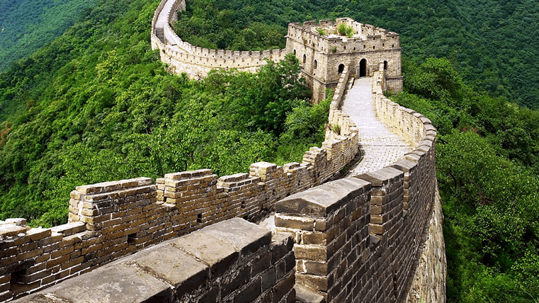  A panoramic view of the Great Wall of China stretching across mountains, symbolising ancient engineering and cultural resilience.
